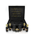 Luxury Jamr Al Oud gift box with black and gold perfume bottles and Arabic calligraphy.