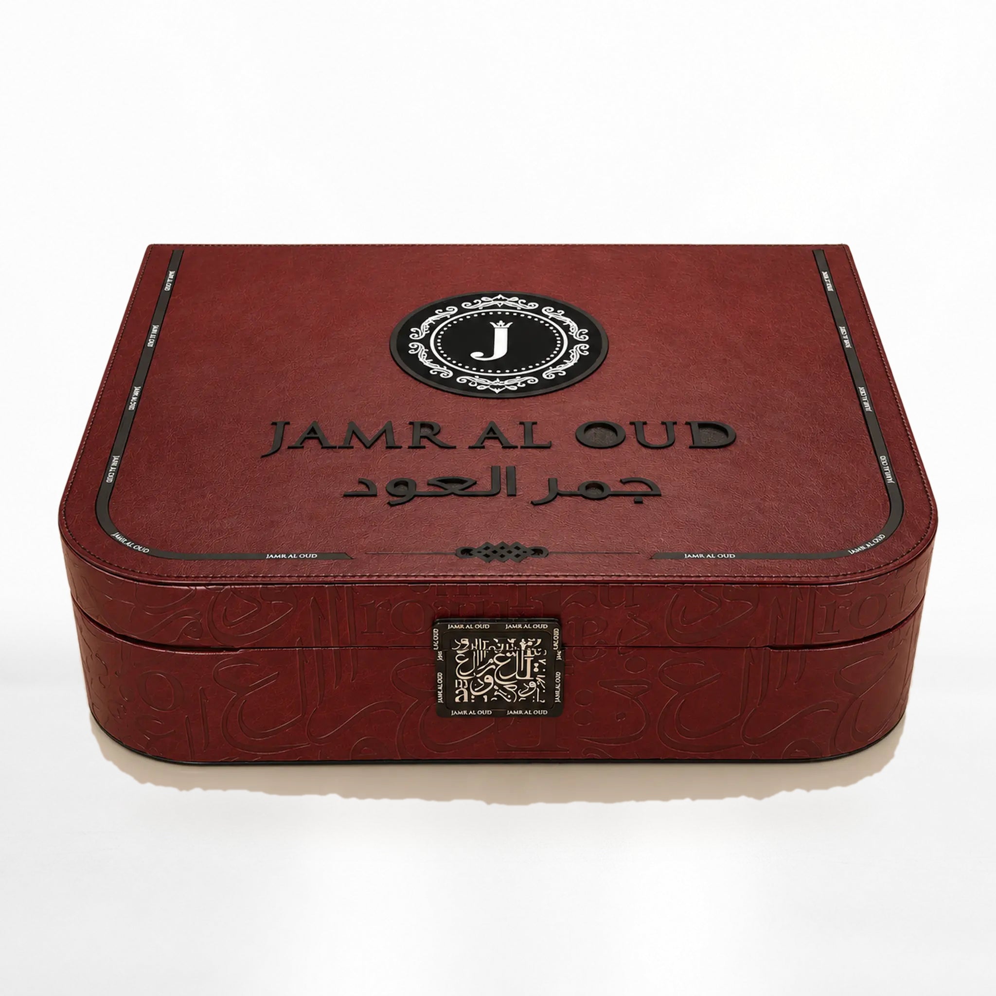Al Mayas Selection Perfume Gift Box by Jamr Al Oud, closed burgundy leather trunk with gold corners, clasp and Jamr Al Oud emblem.