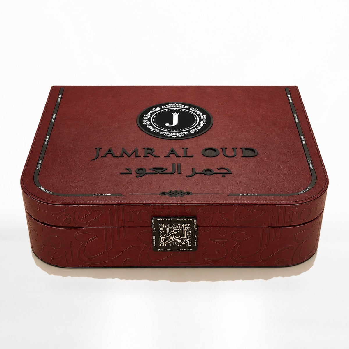 Al Mayas Selection Perfume Gift Box by Jamr Al Oud, closed burgundy leather trunk with gold corners, clasp and Jamr Al Oud emblem.