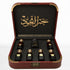 Al Mayas Selection Perfume Gift Box by Jamr Al Oud, open burgundy leather box with six perfume bottles, one dokhoon jar and gold corner details.