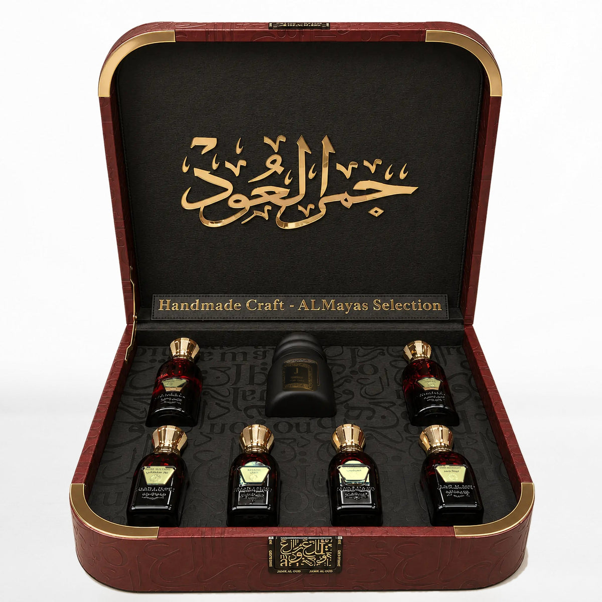 Al Mayas Selection Perfume Gift Box by Jamr Al Oud, open burgundy leather box with six perfume bottles, one dokhoon jar and gold corner details.
