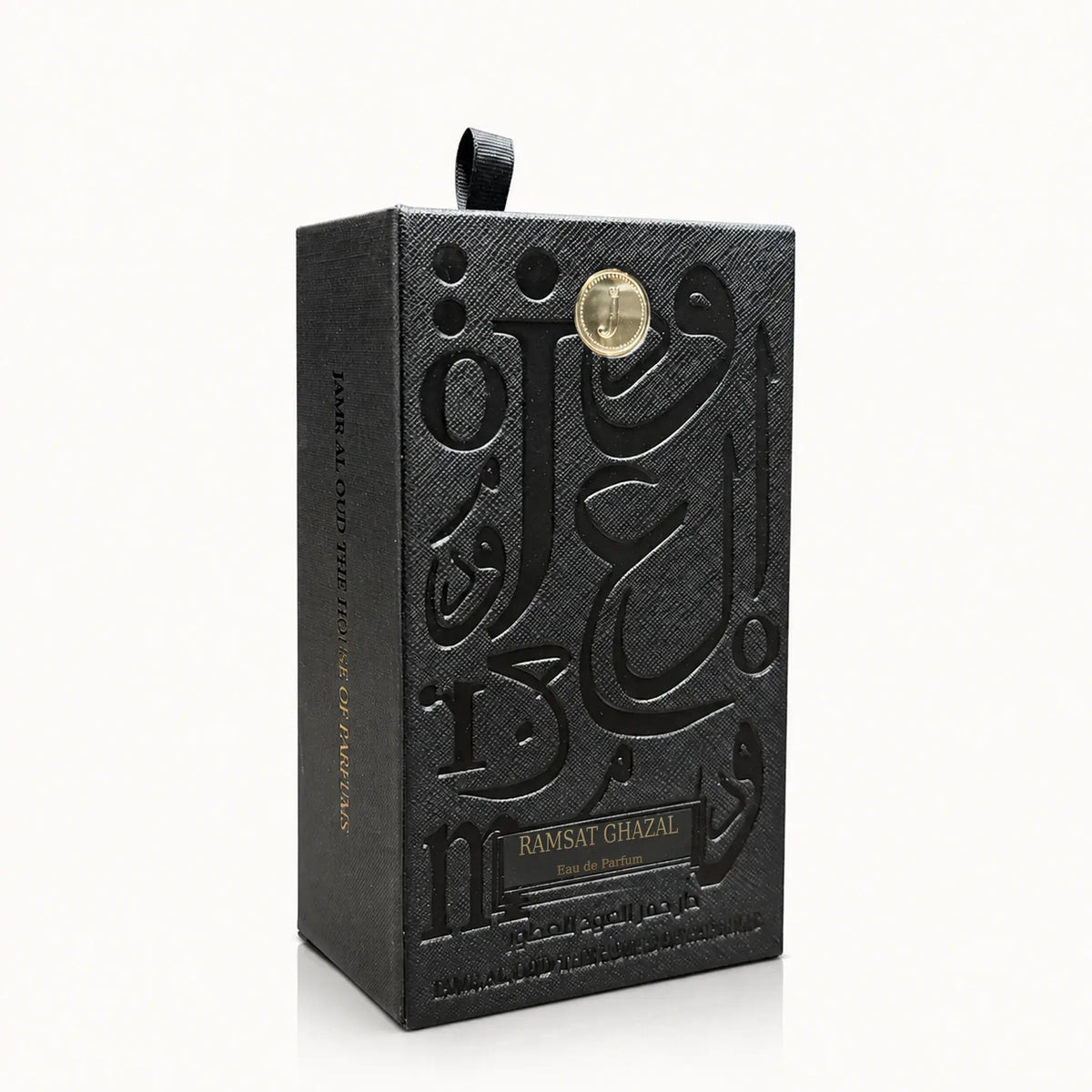 Ramsat Ghazal Perfume by Jamr Al Oud, black presentation box with embossed Arabic calligraphy and a gold emblem.